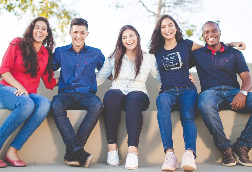 Students sitting together on a bench